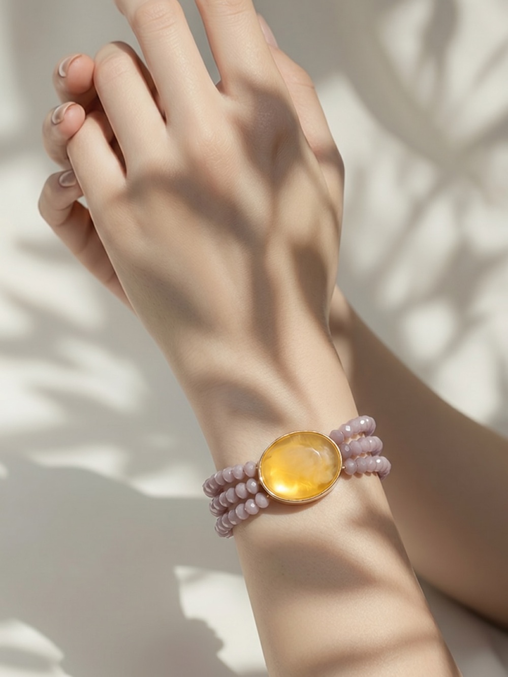 Plunder bracelet features lavender glass beads , prominent yellow resin stone